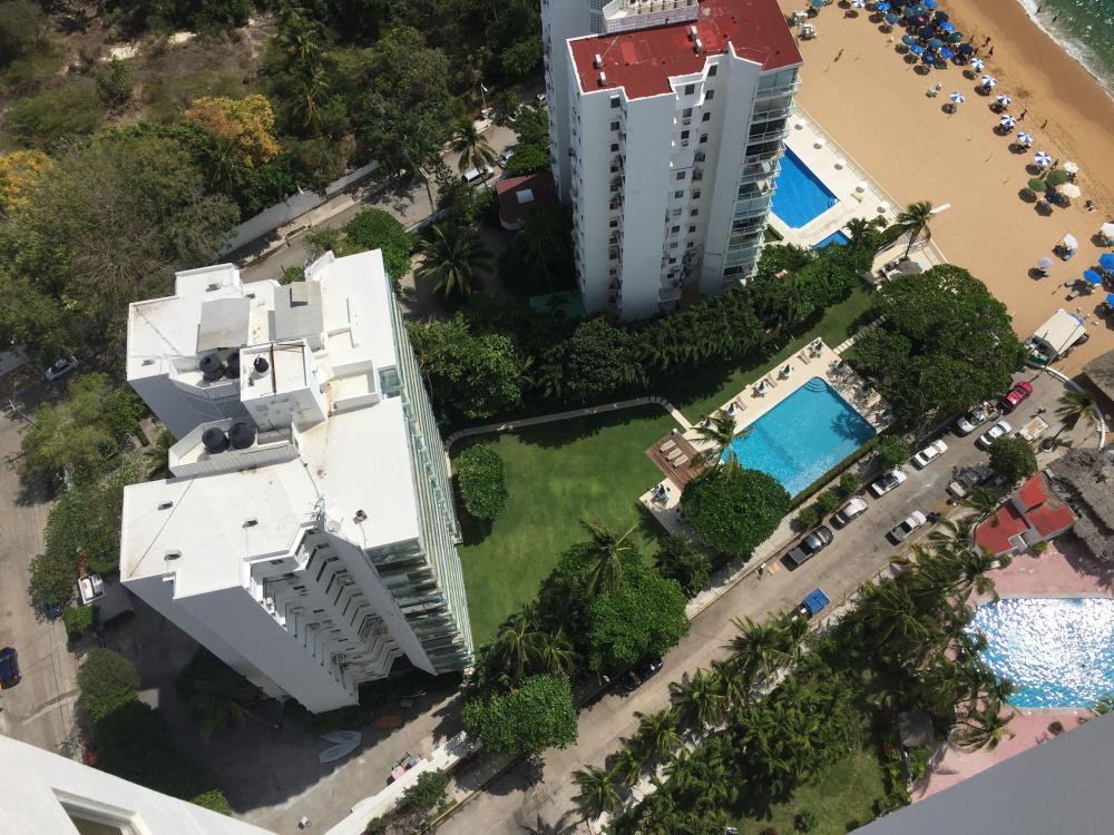 Looking down at Fragata Yucatan street and Icacos Beach from a 30th floor balcony at La Palapa Acapulco